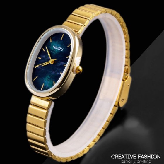 ساعت مچی زنانه بیضی بند استیل طلایی صفحه سورمه ایی نایدو NAIDU  +باطری اضافی کد 2518