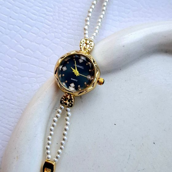 ساعت مچی زنانه بند استیل مرواریدی طلایی مجلسی شیک صفحه نمایش گرد نگین دار مشکی ضدآب GHANEL+باطری اضافی کد 2761