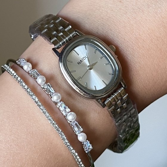 ساعت مچی زنانه نایدو NAIDU مدل صفحه بیضی سفید بند استیل+باطری اضافی کد 3134