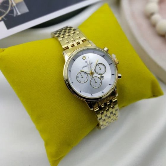 ساعت زنانه رومانسون  زن بند طلایی صفحه سفید+باطری اضافی کد 1769